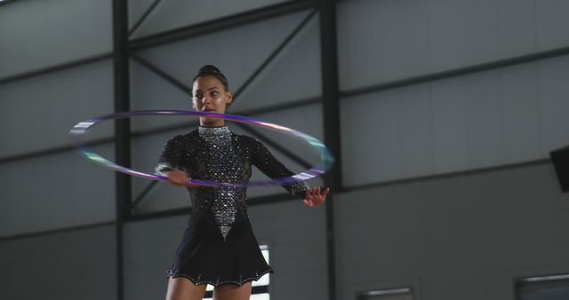 Rhythmic Gymnast Performs with Hula Hoop in Indoor Arena - Download Free Stock Images Pikwizard.com