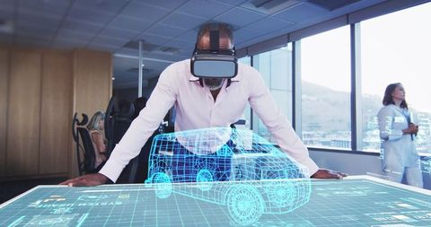 Engineer using vr headset with holographic car in modern office