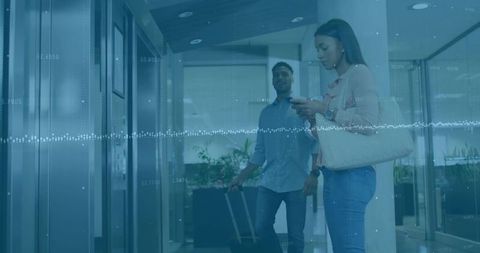 Business Colleagues Checking Mobile in Office Lobby with Digital Data Wave Overlay
