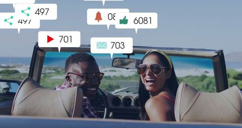 Cheerful Couple Experiencing Adventure on Coast with Social Media Connection