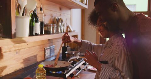 Couple Joyfully Cooking Together in Cozy Home Kitchen
