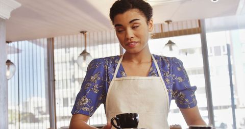 Smiling Barista Serving Coffee in Modern Cafe