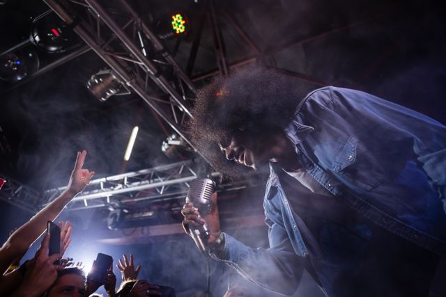 Energetic Singer Performing on Stage in Nightclub - Download Free Stock Photos Pikwizard.com
