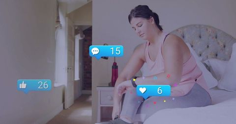 Active woman engaging with social media notifications in bedroom