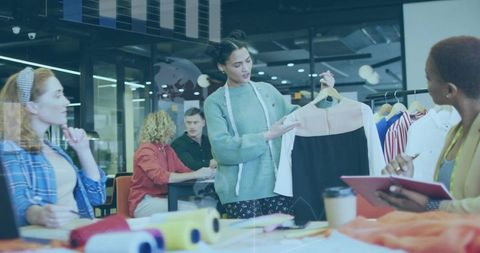 Creative team presenting new dress design during fashion workshop