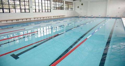 Empty indoor swimming pool with lanes for competitive sports