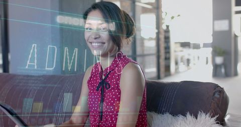 Smiling woman using laptop with digital security hologram overlay