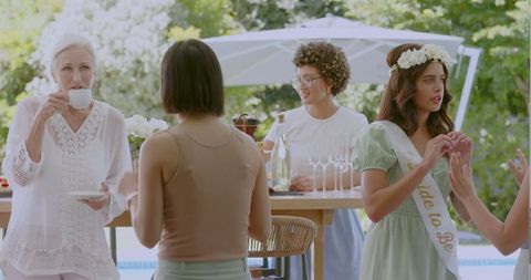 Women Celebrating at a Poolside Bridal Shower Event