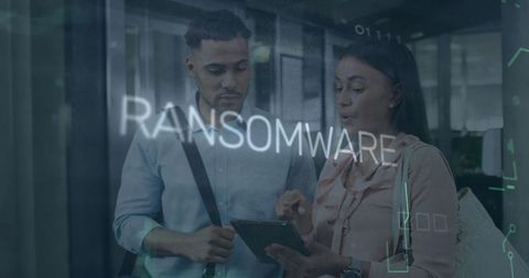 Business Professionals Collaborating on Cybersecurity Tablet with Ransomware Alert