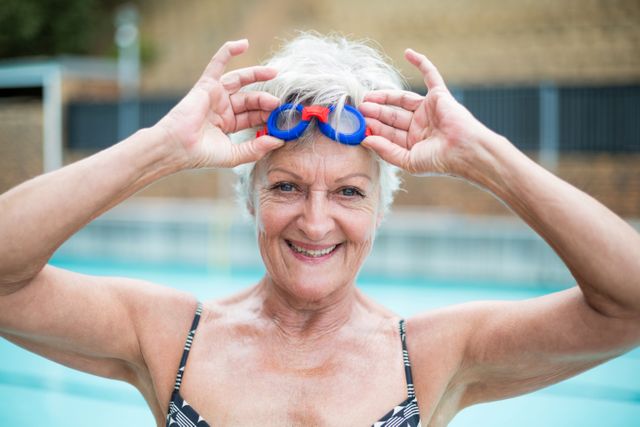 Portrait of senior woman holding swimming goggles