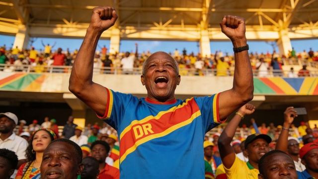 Senior fan cheering and raising fists in colorful dr jersey amid energetic stadium crowd