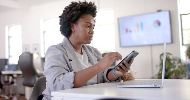 Confident Businesswoman Analyzing Data on Smartphone in Modern Office - Download Free Stock Images Pikwizard.com