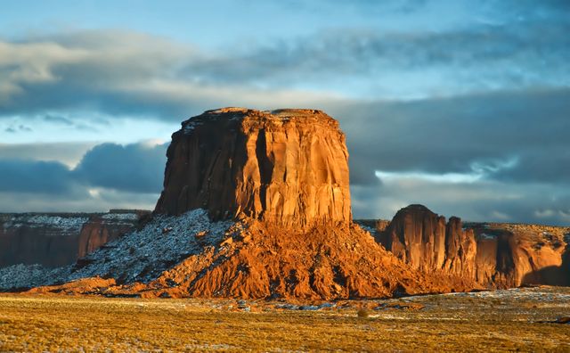 This stunning sunrise scene showcases a majestic butte in Monument Valley, highlighting its towering sandstone formation and vivid colors. Ideal for use in travel and tourism promotions, nature documentaries, educational materials on geology, and inspirational posters for outdoor adventures.