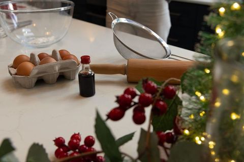 Preparing holiday baking on marble countertop with rolling pin, eggs and festive decor