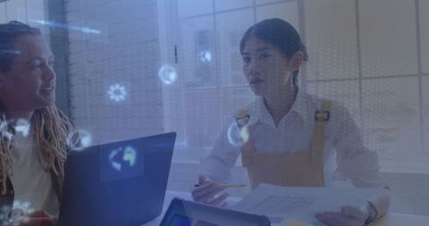 Business Colleagues Analyzing Data with Holographic Technology in Office