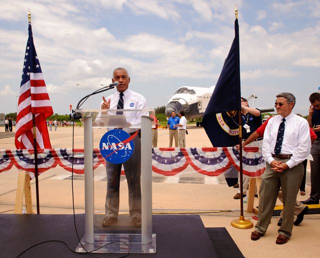 NASA administrator Charles Bolden addresses Kennedy Space Center employees and contractors as Kennedy Space Center director Robert Cabana, right, looks on as space shuttle Atlantis (STS-135) sits in the background near the Orbiter Processing Facility (OPF) at a wheels stop event, Thursday, July 21, 2011, in Cape Canaveral, Fla. Atlantis returned to Kennedy early Thursday following a 13-day mission to the International Space Station (ISS) and marking the end of the 30-year Space Shuttle Program. Overall, Atlantis spent 307 days in space and traveled nearly 126 million miles during its 33 flights. Atlantis, the fourth orbiter built, launched on its first mission on Oct. 3, 1985. Photo Credit: (NASA/Paul E. Alers)