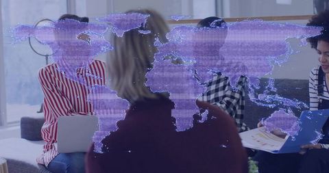 Diverse team collaborating in modern office lounge with holographic world map overlay