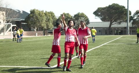 Team Victory Celebrating Soccer Players in Red Stripes