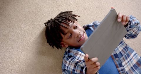 Happy African American Boy Enjoying Tablet Time at Home