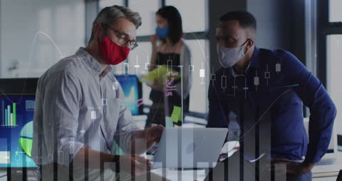 Colleagues Analyzing Data on Laptop with Financial Charts Overlay