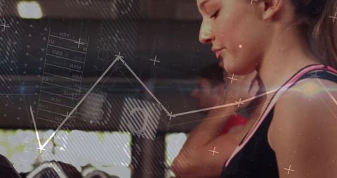 Young woman focused on treadmill workout with fitness analytics