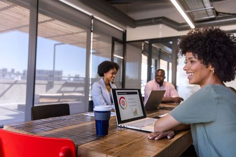 Diverse professionals sharing innovative ideas in modern office setting