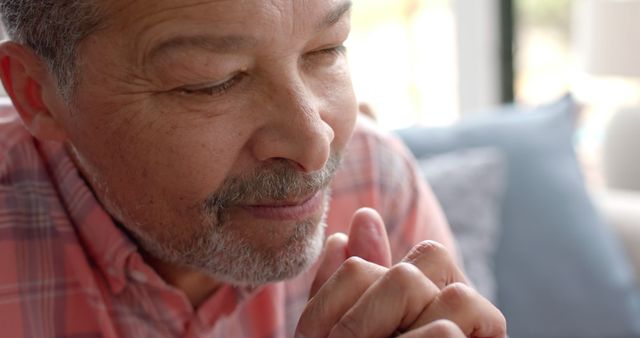 Senior Man Praying at Home with Eyes Closed and Hands Clasped - Download Free Stock Images Pikwizard.com