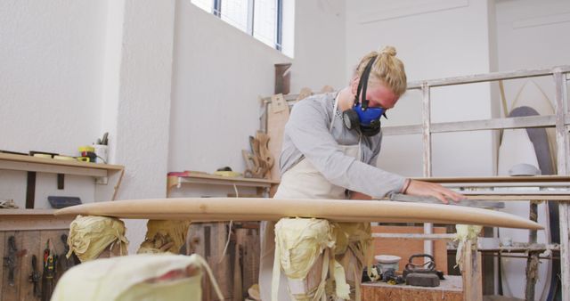 Female Artisanal Worker Shaping Surfboard in Workshop - Download Free Stock Images Pikwizard.com