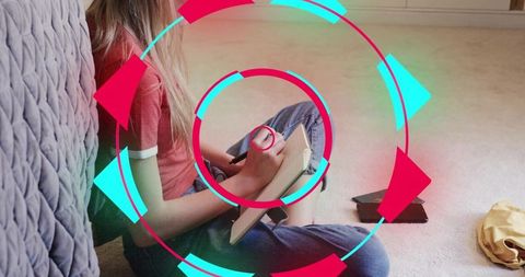 Young woman writing in notebook on bedroom floor with neon circular overlay