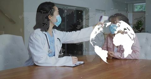 Masked clinician measuring forehead temperature with infrared thermometer during home visit