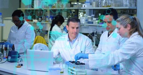 Collaborative Scientists Analyzing Samples with Laptop and Tube Racks in Laboratory