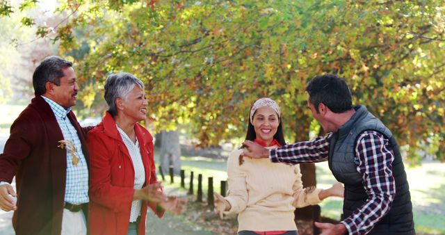 Family enjoying walk together in park on autumn day - Download Free Stock Images Pikwizard.com