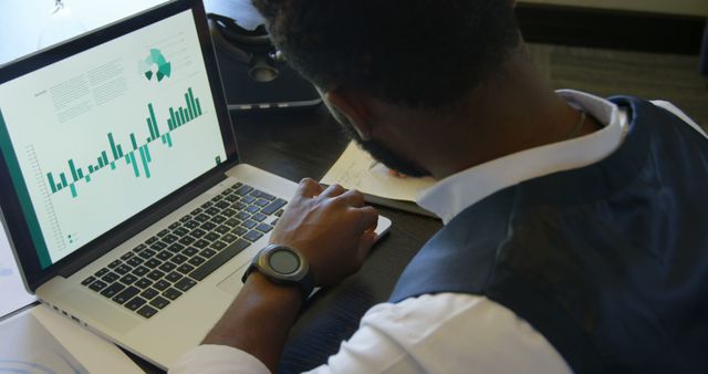 Businessman Analyzing Financial Data on Laptop in Office Setting - Download Free Stock Images Pikwizard.com