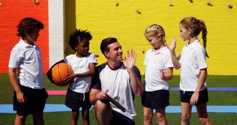 Children Engaging in Basketball Practice with Coach Outdoors - Download Free Stock Images Pikwizard.com