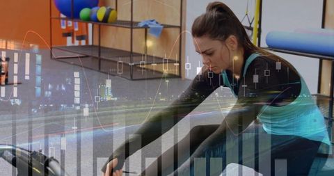 Focused woman stretching with foam roller in gym with finance data overlay and analytics