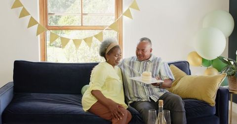 Senior Couple Embraces During Intimate Birthday Celebration at Home