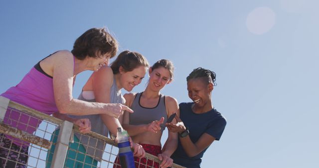 Diverse group of women exercising outdoors and smiling at phone - Download Free Stock Images Pikwizard.com