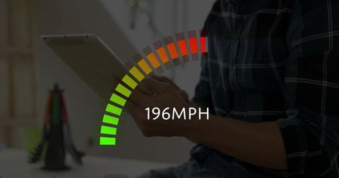 Man using tablet displaying high-speed gauge 196mph digital dashboard concept for performance test