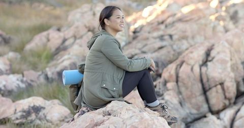 Woman Enjoying Mountain View on Rocky Terrain During Hike