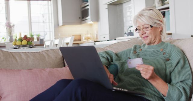 Senior Woman Online Shopping on Laptop Holding Credit Card in Modern Home - Download Free Stock Images Pikwizard.com