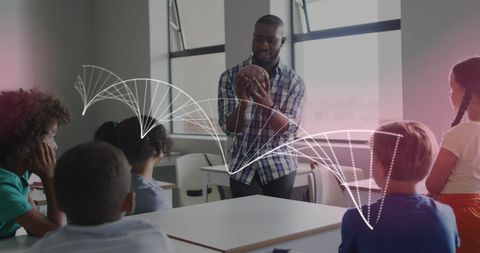 Teacher presenting brain model with dna overlay in classroom