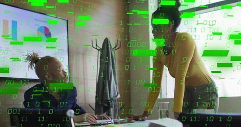 Collaborating Over Data Dashboard with Green Binary Code Overlay in Modern Office Meeting