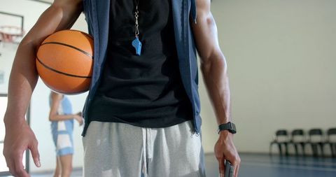 Coach Mentoring Player in Basketball Training Session