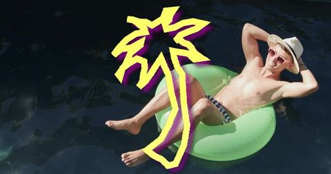 Shirtless man relaxing on lime pool ring floating over dark water with neon palm graphic