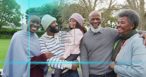 Multigenerational Family Smiling Together on Park Bench with Little Girl in Pink Beanie