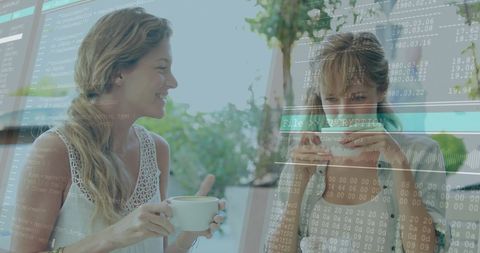 Women enjoying coffee with digital data processing overlay