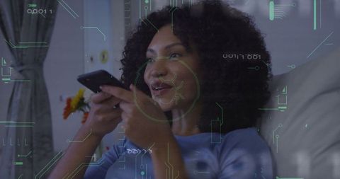 Woman Interacting with Technology at Home Through Smartphone