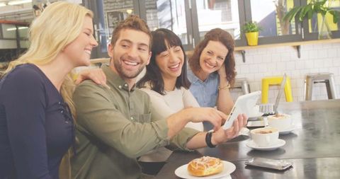 Cheerful Friends Socializing in Modern Café Environment