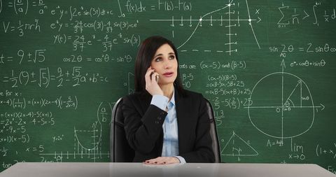 Woman Speaking on Phone With Chalkboard of Math Equations