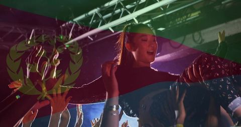 Crowd-surfing young woman under colorful stage lights at energetic live concert